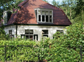 Characteristic house with a garden, surrounded by forest